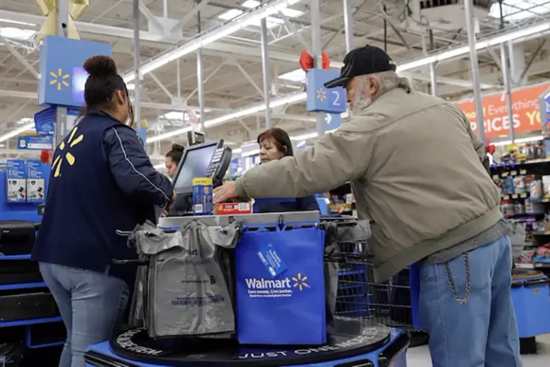 A customer bags his groceries after shopping at a Walmart store ahead of the Thanksgiving holiday in Chicago, Illinois, U.S. November 27, 2019. REUTERS/Kamil Krzaczynski