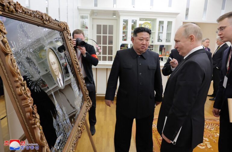 This picture taken on June 19, 2024 and released on June 20, 2024 from North Korea's official Korean Central News Agency (KCNA) via KNS shows North Korea's leader Kim Jong Un presenting a gift to Russia's President Vladimir Putin.
