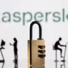 3D printed models of people working on computers and padlock are seen in front of a displayed Kaspersky logo in this picture illustration taken, February 1, 2022. REUTERS/Dado Ruvic/Illustration/File Photo