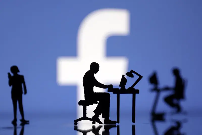 Figurines with computers and smartphones are seen in front of Facebook logo in this illustration, July 24, 2022. REUTERS/Dado Ruvic/Illustration