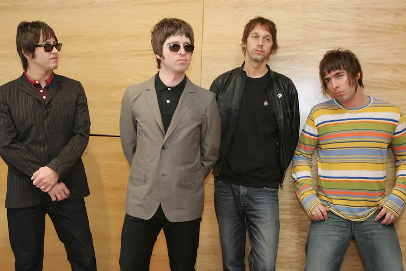 Members of British rock band Oasis rhythm guitarist Gem Archer, lead guitarist Noel Gallagher, bass guitarist Andy Bell and lead vocals Liam Gallagher pose during a news conference in Hong Kong February 25, 2006. They will hold a concert "Oasis-Live in Hong Kong" on Saturday night. REUTERS/Paul Yeung/File Photo