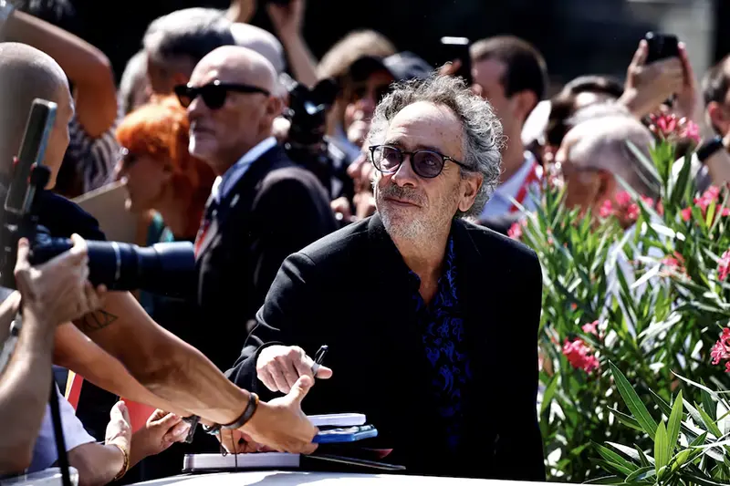 Director Tim Burton signs autographs, on the day of a photocall for the film "Beetlejuice Beetlejuice", which is screening out of competition, at the 81st Venice Film Festival, Venice, Italy, August 28, 2024. REUTERS/Yara Nardi