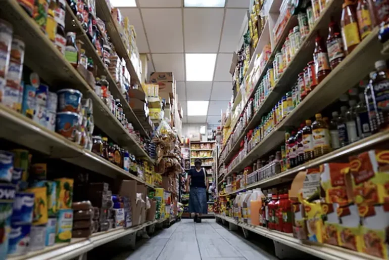 A woman shops for groceries at El Progreso Market in the Mount Pleasant neighborhood of Washington, D.C., U.S., August 19, 2022. REUTERS/Sarah Silbiger/File Photo