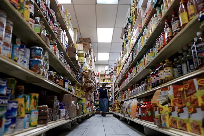 A woman shops for groceries at El Progreso Market in the Mount Pleasant neighborhood of Washington, D.C., U.S., August 19, 2022. REUTERS/Sarah Silbiger/File Photo