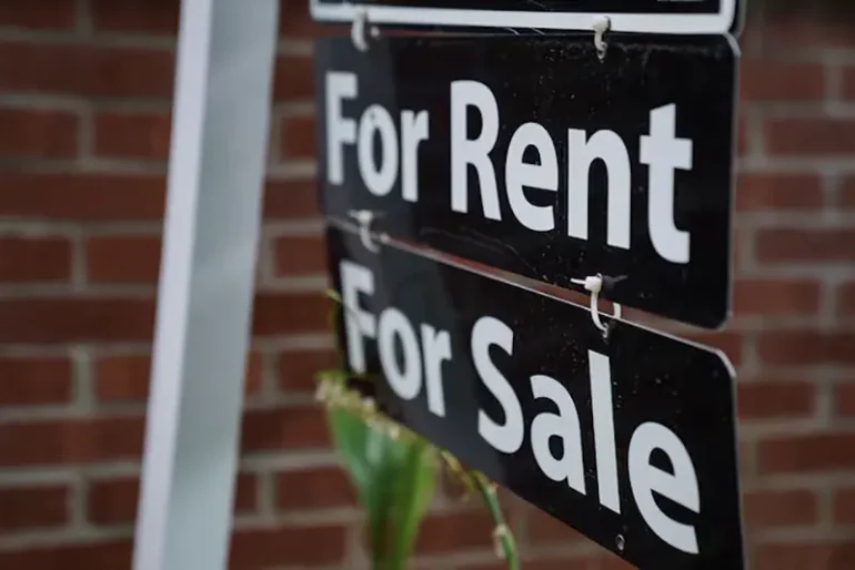 A "For Rent, For Sale" sign is seen outside of a home in Washington, U.S., July 7, 2022. REUTERS/Sarah Silbiger/File Photo