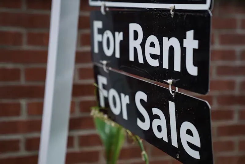 A "For Rent, For Sale" sign is seen outside of a home in Washington, U.S., July 7, 2022. REUTERS/Sarah Silbiger/File Photo