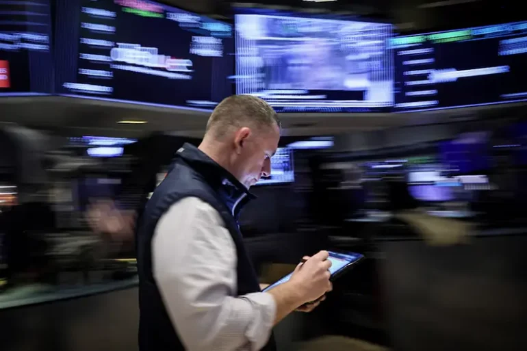 A trader works on the floor at the New York Stock Exchange (NYSE) in New York City, U.S., March 7, 2024. REUTERS/Brendan McDermid/File Photo