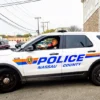 A Nassau County Police officer sits in front of a crime scene at 130 Secatogue Ave. October 29, 2014 in Farmingdale, New York. According to reports police found the decapitated body of a woman outside a apartment complex believed to be beheaded by a man who then jumped to his death in front of a Long Island railroad train. (Photo by Andrew Theodorakis/Getty Images)