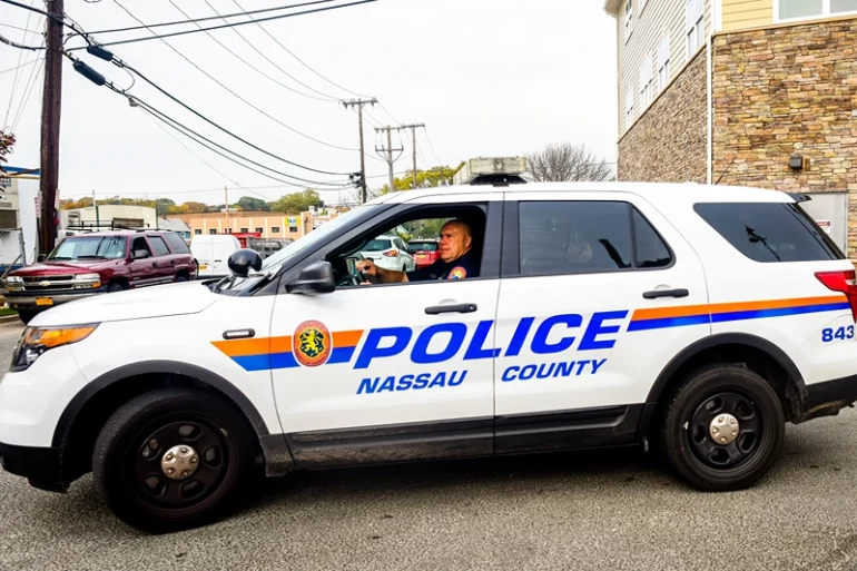 A Nassau County Police officer sits in front of a crime scene at 130 Secatogue Ave. October 29, 2014 in Farmingdale, New York. According to reports police found the decapitated body of a woman outside a apartment complex believed to be beheaded by a man who then jumped to his death in front of a Long Island railroad train. (Photo by Andrew Theodorakis/Getty Images)