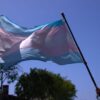 A Transgender Pride Flag is held above the crowd of LGBTQ+ activists during the Los Angeles LGBT Center's "Drag March LA: The March on Santa Monica Boulevard", in West Hollywood, California, on Easter Sunday April 9, 2023. The march comes in response to more than 400 pieces of legislation targeting the LGBTQ+ community that government officials across the United States have proposed or passed in 2023. (Photo by ALLISON DINNER / AFP) (Photo by ALLISON DINNER/AFP via Getty Images)