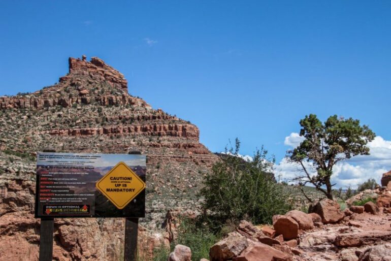 Posted signs warn tourists and hikers of the dangers of hiking in the Grand Canyon on May 14, 2019. - The Grand Canyon experienced an unusual number of accidental deaths this spring. Despite calls for caution, the risky behavior persists. (Photo by Sébastien DUVAL / AFP) (Photo credit should read SEBASTIEN DUVAL/AFP via Getty Images)