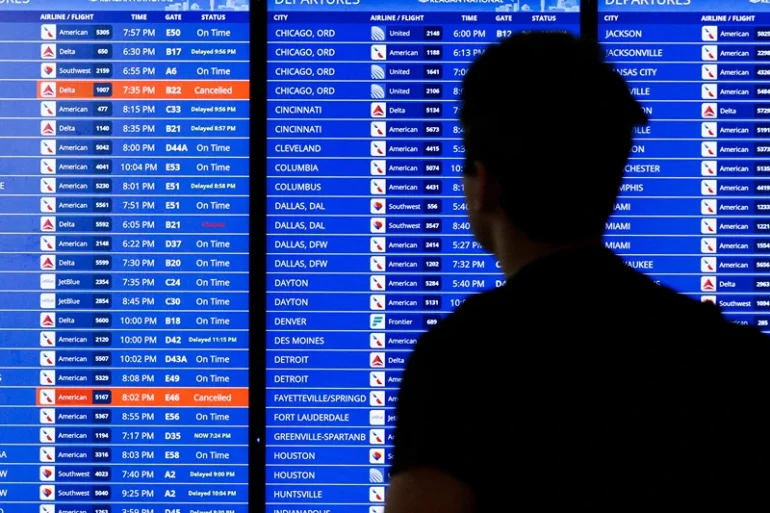 A flight departure information board is seen on Tuesday July 23, 2024 at Ronald Reagan Airport in Arlington, Virginia. A massive Crowdstrike outage impacting Microsoft systems continued to cause residual delays for air travel. (Photo by Aaron Schwartz / Middle East Images / Middle East Images via AFP) (Photo by AARON SCHWARTZ/Middle East Images/AFP via Getty Images)