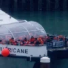 : Migrants are brought ashore after being picked up in the English Channel on November 16, 2023 in Dover, United Kingdom. Rishi Sunak has pledged to introduce emergency legislation and negotiate a new treaty with Rwanda, ensuring that individuals deported from the UK will not be returned to their home countries. The announcement was made in response to the Supreme Court's ruling that the government's controversial plan to fly asylum seekers arriving by small boats to Rwanda as illegal. The proposal, introduced by Boris Johnson in April 2022, aimed to deter migrants from crossing the English Channel. (Photo by Dan Kitwood/Getty Images)