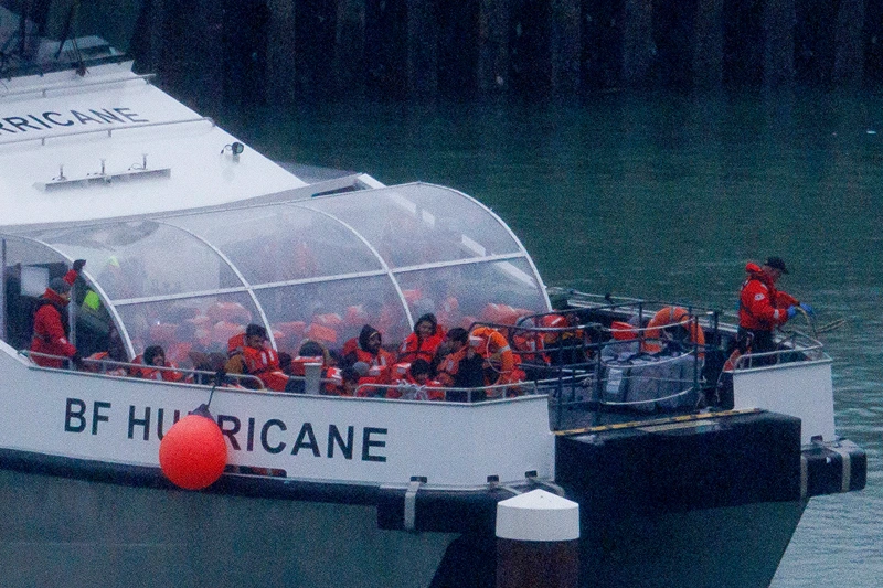 : Migrants are brought ashore after being picked up in the English Channel on November 16, 2023 in Dover, United Kingdom. Rishi Sunak has pledged to introduce emergency legislation and negotiate a new treaty with Rwanda, ensuring that individuals deported from the UK will not be returned to their home countries. The announcement was made in response to the Supreme Court's ruling that the government's controversial plan to fly asylum seekers arriving by small boats to Rwanda as illegal. The proposal, introduced by Boris Johnson in April 2022, aimed to deter migrants from crossing the English Channel. (Photo by Dan Kitwood/Getty Images)