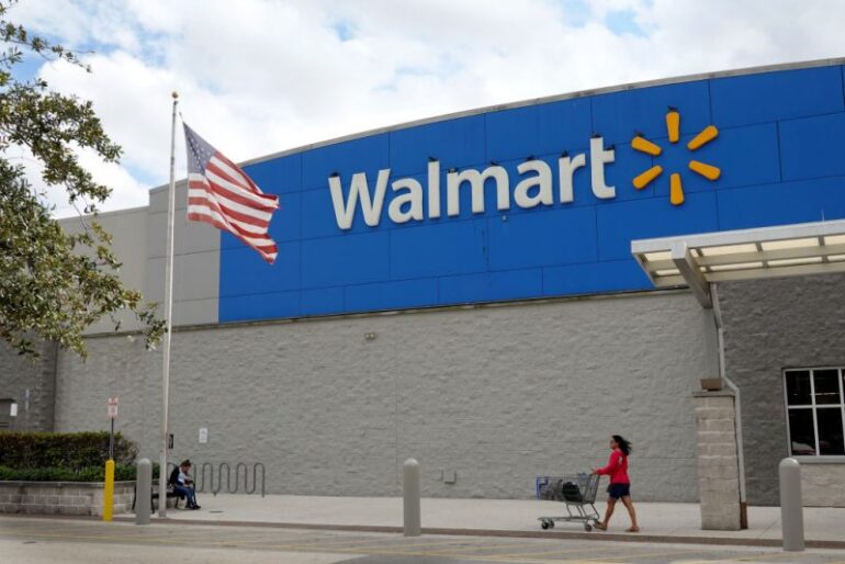 MIAMI, FLORIDA - JANUARY 24: A customer leaves a Walmart store on January 24, 2023 in Miami, Florida. Walmart announced that it is raising its minimum wage for store employees in early March, store employees will make between $14 and $19 an hour. They currently earn between $12 and $18 an hour. (Photo by Joe Raedle/Getty Images)