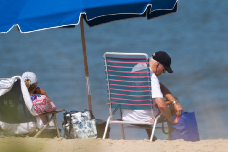 President Joe Biden and first lady Jill Biden sit at the beach in Rehoboth Beach, Del