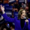 U.S. Vice President Kamala Harris in a blue suit, speaking into a microphone at her rally in Milwaukee, Wisconsin, for a live broadcast to the Democratic National Convention