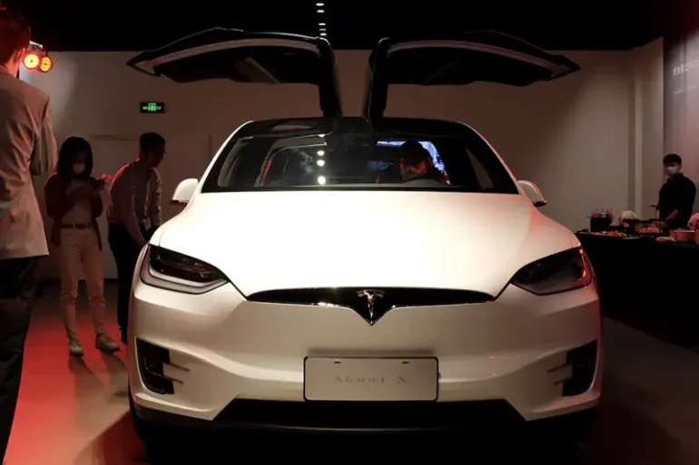 People check a Tesla Model X sport utility vehicle at a new Tesla showroom in Shanghai, China May 8, 2020. REUTERS/Yilei Sun