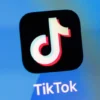 In this photo illustration, the TikTok app logo is displayed on an iPhone on February 28, 2023 in London, England. This week, the US government and European Union's parliament have announced bans on installing the popular social media app on staff devices. (Photo by Dan Kitwood/Getty Images)