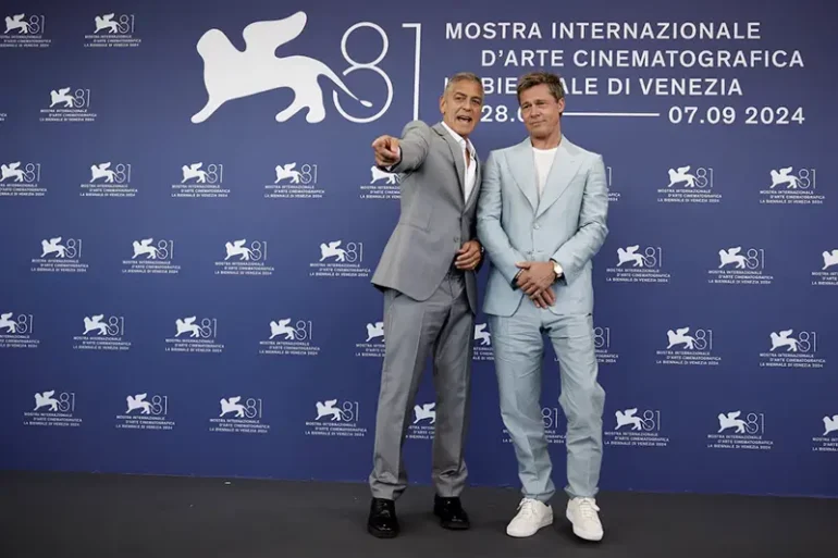 Cast members Brad Pitt and George Clooney pose during a photocall for the movie "The Wolfs" out of competition, at the 81st Venice Film Festival, Venice, Italy, September 1, 2024. REUTERS/Louisa Gouliamaki