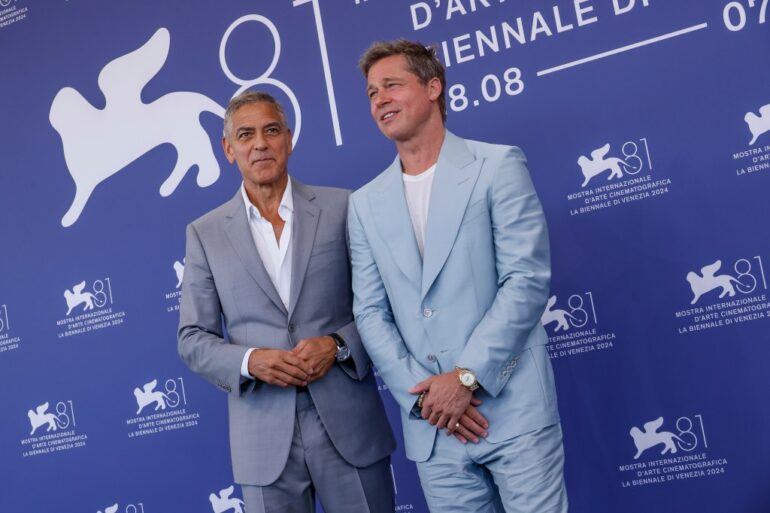 George Clooney, left, and Brad Pitt pose for photographers at the photo call for the film 'Wolfs' during the 81st edition of the Venice Film Festival in Venice, Italy, on Sunday, Sept. 1, 2024.