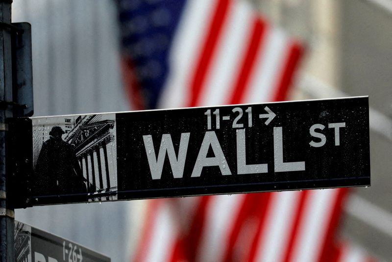 FILE PHOTO: Raindrops hang on a sign for Wall Street outside the New York Stock Exchange in Manhattan in New York City, New York, U.S., October 26, 2020. REUTERS/Mike Segar