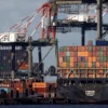 A ship stacked with shipping containers is unloaded on a pier at Port Newark, New Jersey, U.S., November 19, 2021. REUTERS/Mike Segar/File Photo