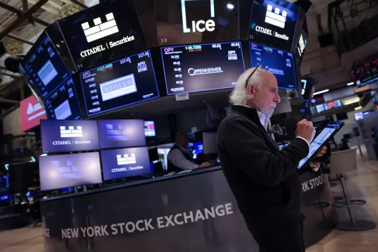 A trader works on the trading floor at The New York Stock Exchange (NYSE) following the Federal Reserve rate announcement, in New York City, U.S., September 18, 2024. REUTERS/Andrew Kelly