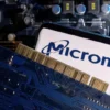 A smartphone with a displayed Micron logo is placed on a computer motherboard in this illustration taken March 6, 2023. REUTERS/Dado Ruvic/Illustration/File Photo