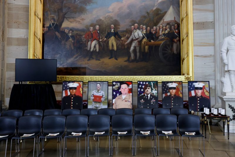 WASHINGTON, DC - SEPTEMBER 10: Images of the 13 American service members who died in the suicide bombing at Hamid Karzai International Airport in Afghanistan sit on display ahead of a Gold Medal Ceremony in the U.S. Capitol Rotunda on September 10, 2024 in Washington, DC. Senate and House leadership will attend the ceremony along with families of the 13 fallen service members. (Photo by Anna Moneymaker/Getty Images)