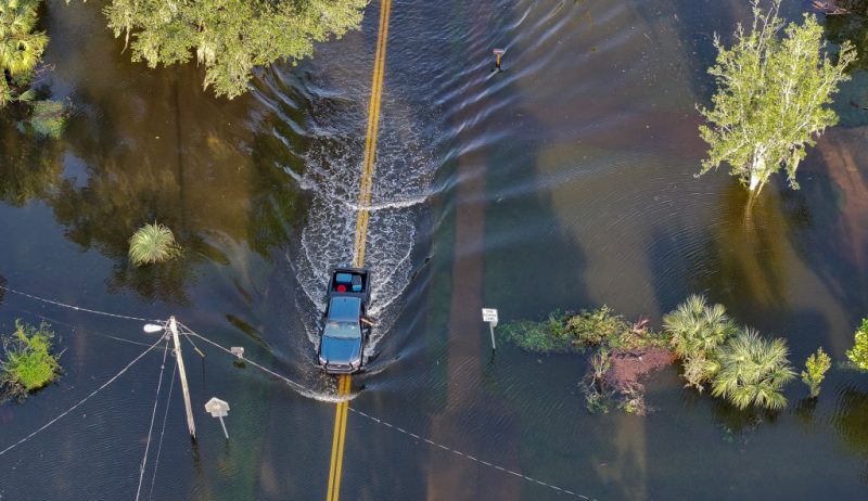 CRYSTAL RIVER, FLORIDA - SEPTEMBER 27: In this aerial view, a vehicle drives through flood waters after Hurricane Helene hit the area as it passed offshore on September 27, 2024 in Crystal River, Florida. Hurricane Helene made landfall Thursday night in Florida's Big Bend with winds up to 140 mph and storm surges. (Photo by Joe Raedle/Getty Images)