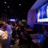 People attend a watch party for the US Presidential debate between Vice President and Democratic presidential candidate Kamala Harris and former US President and Republican presidential candidate Donald Trump at The Admiral in Washington, DC, on September 10, 2024. (Photo by Allison Bailey / AFP) (Photo by ALLISON BAILEY/AFP via Getty Images)