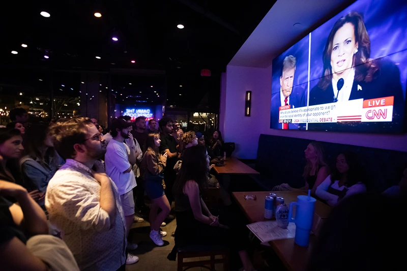 People attend a watch party for the US Presidential debate between Vice President and Democratic presidential candidate Kamala Harris and former US President and Republican presidential candidate Donald Trump at The Admiral in Washington, DC, on September 10, 2024. (Photo by Allison Bailey / AFP) (Photo by ALLISON BAILEY/AFP via Getty Images)