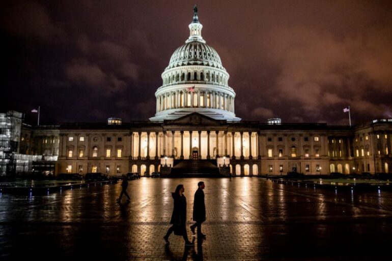 WASHINGTON, DC - DECEMBER 17: People walk along the east front plaza of the US Capitol as night falls on December 17, 2019 in Washington, DC. The House Rules Committee is holding a full committee hearing to set guidelines for the upcoming debate and vote on the two Articles of Impeachment of President Trump in the House of Representatives. (Photo by Samuel Corum/Getty Images)