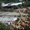 The Rocky Broad River flows into Lake Lure and overflows the town with debris from Chimney Rock, North Carolina after heavy rains from Hurricane Helene on September 28, 2024, in Lake Lure, North Carolina. Approximately six feet of debris piled on the bridge from Lake Lure to Chimney Rock, blocking access. (Photo by Melissa Sue Gerrits/Getty Images)