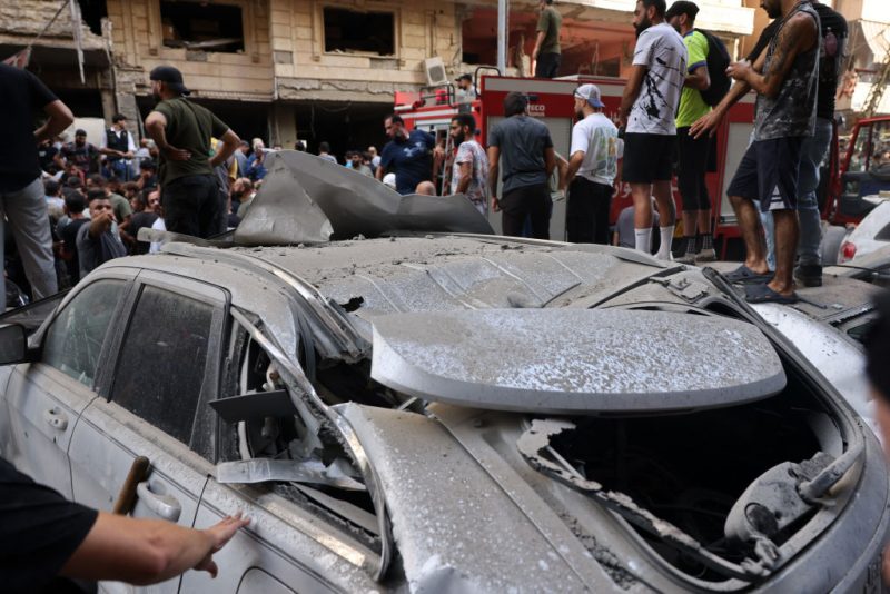 People check the damage following an Israeli strike in Beirut's southern suburbs on September 20, 2024. The Israeli military announced that the commander of Hezbollah's elite Radwan unit, Ibrahim Aqil, and other senior figures of the Lebanese armed group had been killed in the air strike. (Photo by ANWAR AMRO / AFP) (Photo by ANWAR AMRO/AFP via Getty Images)