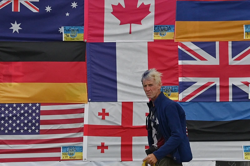 This photograph taken on Independence Square in Kyiv on June 23, 2022 shows US citizen Ryan Wesley Routh sticking up national flags of the countries helping Ukraine. US media said it was Routh, 58, who was arrested after US Secret Service agents "opened fire on a gunman" carrying an AK-47 style rifle near the boundary of Donald Trump's Florida golf course where the former president was golfing on September 15, 2024. (Photo by Sergei SUPINSKY / AFP) (Photo by SERGEI SUPINSKY/AFP via Getty Images)