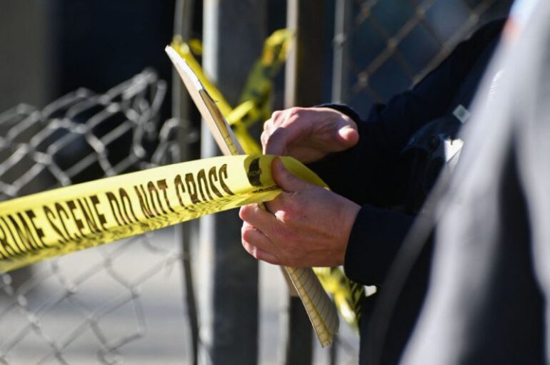 A San Mateo County Sheriff officer puts up police tape at a crime scene after a shooting at the Spanish Town shops in Half Moon Bay, California, on January 24, 2023. - A suspected gunman was in custody Monday over the killing of seven people in a rural community in northern California, just two days after a mass shooting at a Lunar New Year celebration near Los Angeles. (Photo by Samantha Laurey / AFP) (Photo by SAMANTHA LAUREY/AFP via Getty Images)