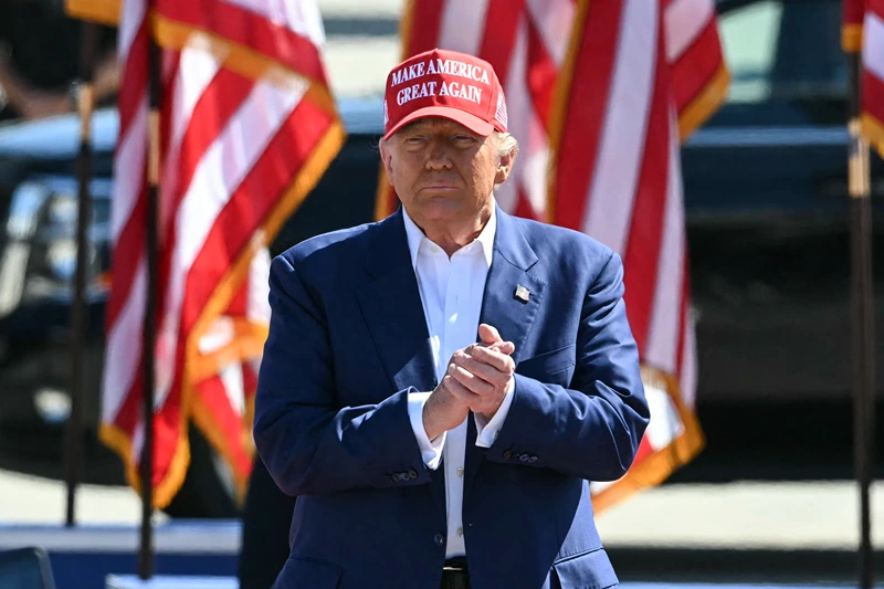 Former US President and Republican presidential candidate Donald Trump arrives onstage to speak during a campaign rally at the Aero Center in Wilmington, North Carolina, September 21, 2024. (Photo by Jim WATSON / AFP) (Photo by JIM WATSON/AFP via Getty Images)