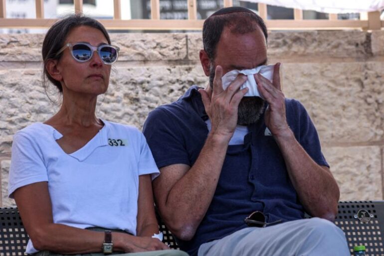 Jonathan Polin and Rachel Goldberg, parents of killed US-Israeli hostage Hersh Goldberg-Polin whose body was recovered with five other hostages in Gaza, react during the funeral in Jerusalem on September 2, 2024, amid the ongoing conflict between Israel and the Palestinian militant group Hamas. The six were among 251 hostages seized during Hamas's October 7 attack that triggered the ongoing war between Israel and Hamas. (Photo by GIL COHEN-MAGEN / POOL / AFP) (Photo by GIL COHEN-MAGEN/POOL/AFP via Getty Images)