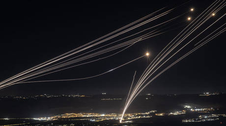 Rockets fired from southern Lebanon are intercepted by Israeli Iron Dome air defence systems over the Upper Galilee region in northern Israel, August 3, 2024