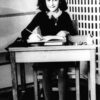 Undated photo of Anne Frank, the young Jewish girl, sitting at a desk