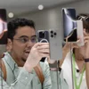 An attendee takes a photo of the new iPhone 16 as Apple holds an event at the Steve Jobs Theater on its campus in Cupertino, California, U.S. September 9, 2024. REUTERS/Manuel Orbegozo/File Photo