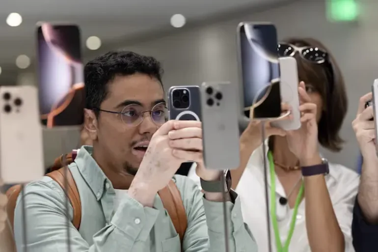 An attendee takes a photo of the new iPhone 16 as Apple holds an event at the Steve Jobs Theater on its campus in Cupertino, California, U.S. September 9, 2024. REUTERS/Manuel Orbegozo/File Photo