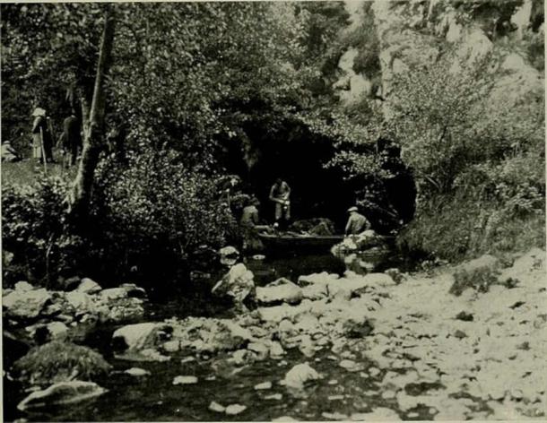 Montesquieu-Avantès, Ariège, Midi-Pyrénées, France. Entrance to the cave of Tuc d'Audoubert, where the river Volp comes back to the surface. Henri Begouën's sons and other people with the raft they used to enter the cave. Photo taken on July 20th, 1913, or 1914, the Begouën family celebrating the "discovery" of the cave (that is, the discovery of its paleolithic art, starting on July 16, 1912). (Public Domain)