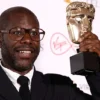 Director Steve McQueen poses with the "Best Factual Series" award for "Uprising" at the British Academy Television Awards in London, Britain, May 8, 2022. REUTERS/Henry Nicholls/File Photo