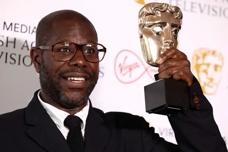 Director Steve McQueen poses with the "Best Factual Series" award for "Uprising" at the British Academy Television Awards in London, Britain, May 8, 2022. REUTERS/Henry Nicholls/File Photo