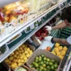 A man arranges produce at Best World Supermarket in the Mount Pleasant neighborhood of Washington, D.C., U.S., August 19, 2022. REUTERS/Sarah Silbiger/File Photo