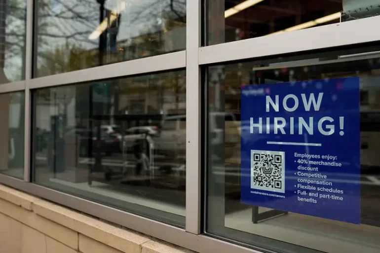 An employee hiring sign with a QR code is seen in a window of a business in Arlington, Virginia, U.S., April 7, 2023. REUTERS/Elizabeth Frantz/File Photo