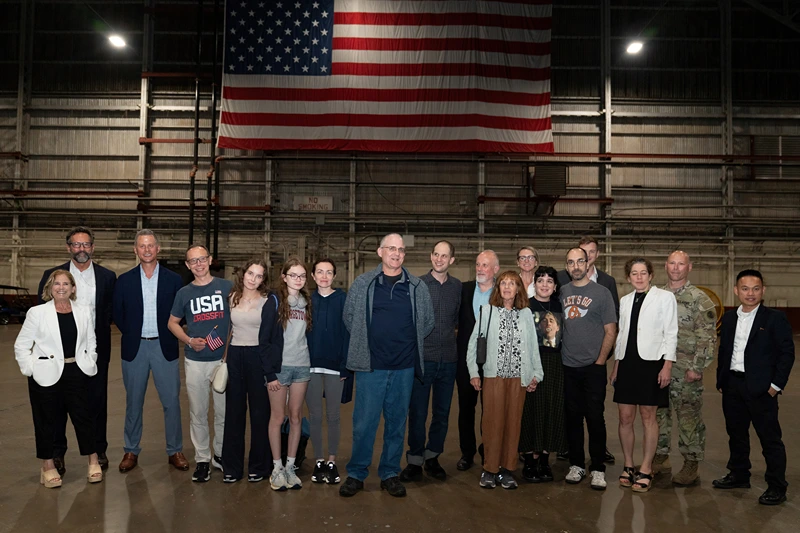 Former prisoners released by Russia, Evan Gershkovich (C), former US marine Paul Whelan (9thL), and journalist US-Russian Alsu Kurmasheva (7thL) pose after landing at Joint Base San Antonio-Kelly Field, Texas, on August 2, 2024. Journalist Evan Gershkovich and fellow prisoners released by Russia landed in the United States late August 1, as part of an extraordinary swap deal struck between Washington and Moscow. A plane carrying Gershkovich, former US marine Paul Whelan, and journalist Alsu Kurmasheva landed at around 11:40 pm (0340 GMT) at Joint Base Andrews near Washington, where President Joe Biden and Vice President Kamala Harris were waiting to greet them. (Photo by SUZANNE CORDEIRO / AFP) (Photo by SUZANNE CORDEIRO/AFP via Getty Images)